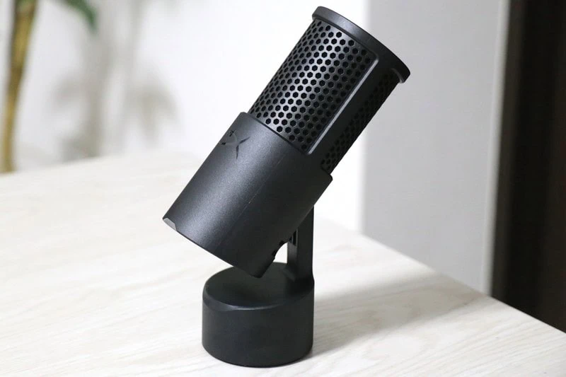 黒色のSolocast 2コンデンサーマイクが、円形の台座に取り付けられ、明るいデスク上で斜め向きに設置されている様子